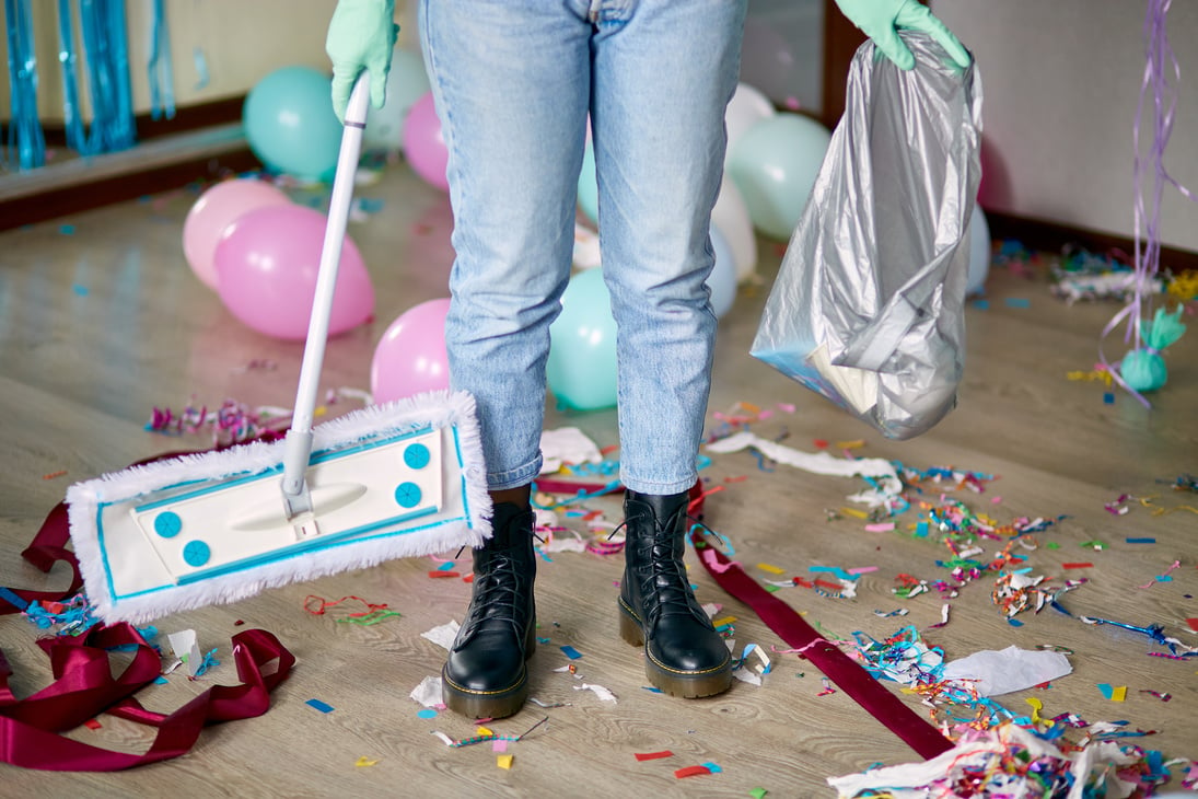 Person Cleaning Mess After Party